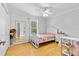 Bright bedroom features hard wood floors, ceiling fan and natural light at 17901 Coralwood Ln, Groveland, FL 34736