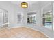 Bright breakfast nook features tile flooring, neutral paint, and large windows with backyard views at 17901 Coralwood Ln, Groveland, FL 34736