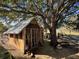Cozy chicken coop nestled beneath a large oak tree, providing shade and a natural environment for poultry at 17901 Coralwood Ln, Groveland, FL 34736