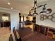 Formal dining room with a large wooden table, chandelier and view into living room at 17901 Coralwood Ln, Groveland, FL 34736