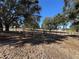 Entrance to the property with a wooden gate and wire fence at 17901 Coralwood Ln, Groveland, FL 34736