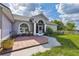 Home featuring a tiled front patio and a well-maintained lawn at 17901 Coralwood Ln, Groveland, FL 34736