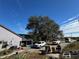 House exterior with driveway and large oak tree at 17901 Coralwood Ln, Groveland, FL 34736