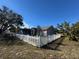 House exterior with white picket fence and windmill at 17901 Coralwood Ln, Groveland, FL 34736