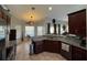 Open kitchen boasting granite counters, stainless steel appliances, and a breakfast bar at 17901 Coralwood Ln, Groveland, FL 34736