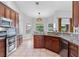 Open kitchen showcasing granite counters, stainless appliances, and light-filled breakfast nook at 17901 Coralwood Ln, Groveland, FL 34736