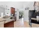 Kitchen boasts granite counters, stainless appliances, and open layout to dining area at 17901 Coralwood Ln, Groveland, FL 34736