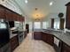 Spacious kitchen with granite countertops, stainless steel appliances, and ample cabinet space at 17901 Coralwood Ln, Groveland, FL 34736