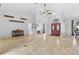 Spacious living area featuring high ceilings, tile floors, and double door entry at 17901 Coralwood Ln, Groveland, FL 34736