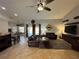 Open living area with leather furniture and a view to kitchen and dining area at 17901 Coralwood Ln, Groveland, FL 34736