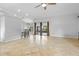 Open living space with tile flooring, neutral walls, and sliding glass doors at 17901 Coralwood Ln, Groveland, FL 34736