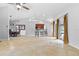 Bright open-concept living area with tile flooring, bar seating, and dining area at 17901 Coralwood Ln, Groveland, FL 34736