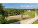 The grass pasture is surrounded by a wood fence, and tall trees for privacy at 17901 Coralwood Ln, Groveland, FL 34736
