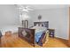 Main bedroom features wood floors, ceiling fan, and dark wood furniture at 17901 Coralwood Ln, Groveland, FL 34736
