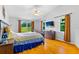 Bright main bedroom with wood floors, fan, and windows for natural light at 17901 Coralwood Ln, Groveland, FL 34736