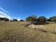 Pasture with trees, fence, and distant home at 17901 Coralwood Ln, Groveland, FL 34736