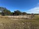 Small, sandy riding arena with wooden fence at 17901 Coralwood Ln, Groveland, FL 34736