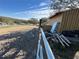Sand riding arena with a storage shed and various construction materials at 17901 Coralwood Ln, Groveland, FL 34736