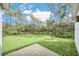 Backyard patio with grassy area and trees at 18 Malauka Pass Ter, Ocklawaha, FL 32179