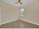 Well-lit bedroom with wood-look flooring and ceiling fan at 18 Malauka Pass Ter, Ocklawaha, FL 32179