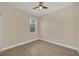 Bright bedroom with wood-look flooring and ceiling fan at 18 Malauka Pass Ter, Ocklawaha, FL 32179