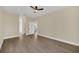 Spacious bedroom with wood-look flooring and ceiling fan at 18 Malauka Pass Ter, Ocklawaha, FL 32179