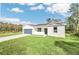 New construction home, featuring a gray garage door and a well-manicured lawn at 18 Malauka Pass Ter, Ocklawaha, FL 32179