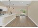 Modern kitchen with island and dining area, features sliding door to outdoor space at 18 Malauka Pass Ter, Ocklawaha, FL 32179