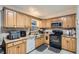 Galley kitchen with wood cabinets, stainless steel appliances, and ample counter space at 1817 W Grant St, Orlando, FL 32805