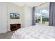 Bedroom with mounted TV, king bed, and large window with view at 2182 Fleming Mist Pl, Kissimmee, FL 34747