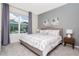 Bedroom with king-size bed, window, and neutral color palette at 2182 Fleming Mist Pl, Kissimmee, FL 34747