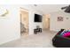 Common area with TV, black couch, en-suite bathroom, and pop art at 2182 Fleming Mist Pl, Kissimmee, FL 34747