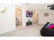 Common area with TV, black couch, and en-suite bathroom at 2182 Fleming Mist Pl, Kissimmee, FL 34747