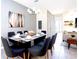 Bright dining room featuring a glass-top table and modern chandelier at 2182 Fleming Mist Pl, Kissimmee, FL 34747