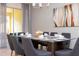 Modern dining room featuring a glass-top table and gray chairs at 2182 Fleming Mist Pl, Kissimmee, FL 34747