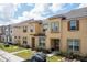 Tan two-story townhome with brown door and landscaping at 2182 Fleming Mist Pl, Kissimmee, FL 34747