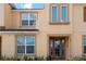 Tan two-story townhome with brown door and landscaping at 2182 Fleming Mist Pl, Kissimmee, FL 34747