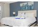 Spacious main bedroom with a king-size bed and blue accent wall at 2182 Fleming Mist Pl, Kissimmee, FL 34747