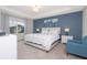 Spacious main bedroom with a king-size bed and blue accent wall at 2182 Fleming Mist Pl, Kissimmee, FL 34747