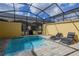 Inviting pool area with covered patio and lounge chairs at 2182 Fleming Mist Pl, Kissimmee, FL 34747