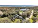 Stunning aerial view of a home nestled in a lush, green landscape with a tranquil lake nearby at 2305 Leeward Cv, Kissimmee, FL 34746