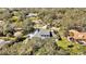 Aerial view showcasing the property's location among mature trees and lush landscaping at 2305 Leeward Cv, Kissimmee, FL 34746