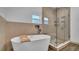 A luxurious bathroom highlighting a soaking tub and seamless glass shower at 2305 Leeward Cv, Kissimmee, FL 34746