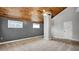 This bedroom features vaulted wood ceilings, neutral carpeting, and natural light at 2305 Leeward Cv, Kissimmee, FL 34746