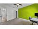 Bedroom with green accent wall and workspace at 2305 Leeward Cv, Kissimmee, FL 34746