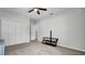 A spacious carpeted bedroom with a ceiling fan and a large closet at 2305 Leeward Cv, Kissimmee, FL 34746