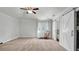 Spacious bedroom with neutral carpet, ceiling fan, a rocking chair and sliding barn door at 2305 Leeward Cv, Kissimmee, FL 34746