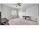Neutral carpeted bedroom with ceiling fan, window, nightstands and a television stand at 2305 Leeward Cv, Kissimmee, FL 34746