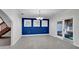 Dining room showcasing a blue accent wall, white trim, and outdoor access at 2305 Leeward Cv, Kissimmee, FL 34746