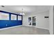 Dining room with tile floor, white trim, blue accent wall and french doors to patio at 2305 Leeward Cv, Kissimmee, FL 34746